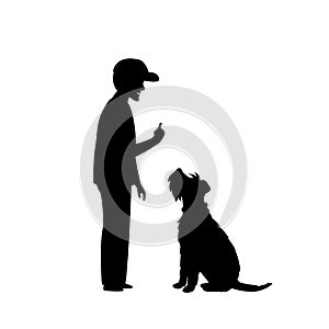 Man teaching his dog basic obedience command sit silhouette photo