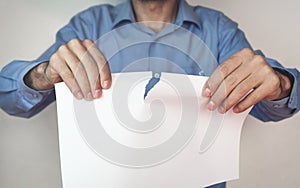 Man tearing blank paper.