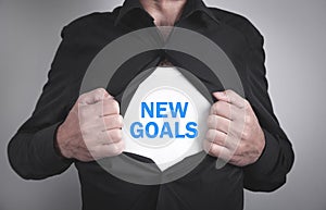 Man tearing his shirt and showing New Goals text