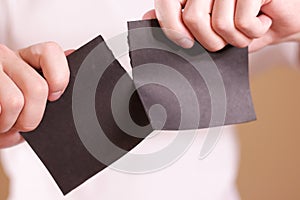 Man tearing a piece of paper in half blank black flyer brochure