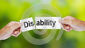 Man tearing the word Disability for Ability