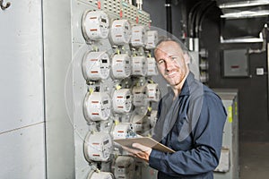 Man Technician servicing at work on electric room