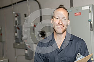 Man Technician servicing at work on electric room