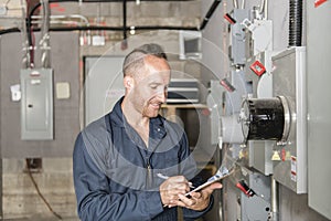 Man Technician servicing at work on electric room