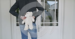 Man, teddy bear and surprise at door, boyfriend and waiting for girlfriend, home and knock. Birthday gift, romance and