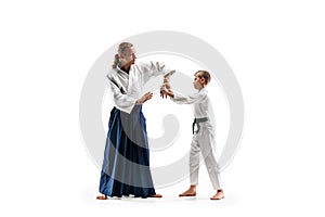 Man and teen boy fighting at aikido training in martial arts school