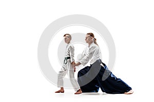 Man and teen boy fighting at aikido training in martial arts school