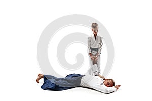 Man and teen boy fighting at aikido training in martial arts school