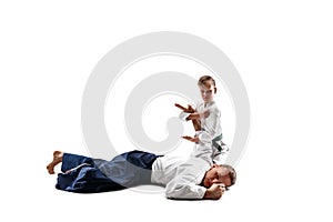 Man and teen boy fighting at aikido training in martial arts school