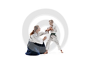 Man and teen boy fighting at aikido training in martial arts school