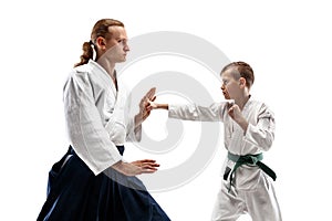 Man and teen boy fighting at aikido training in martial arts school