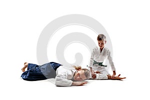 Man and teen boy fighting at aikido training in martial arts school