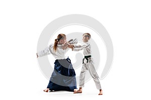 Man and teen boy fighting at aikido training in martial arts school