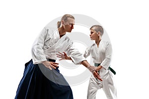 Man and teen boy fighting at aikido training in martial arts school