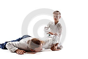 Man and teen boy fighting at aikido training in martial arts school