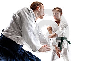 Man and teen boy fighting at aikido training in martial arts school