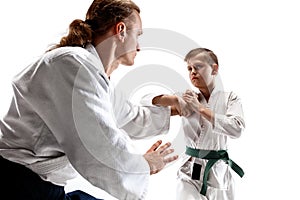 Man and teen boy fighting at aikido training in martial arts school