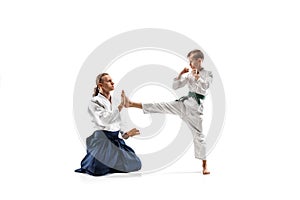 Man and teen boy fighting at aikido training in martial arts school