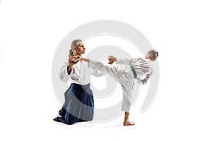 Man and teen boy fighting at aikido training in martial arts school