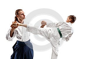 Man and teen boy fighting at aikido training in martial arts school