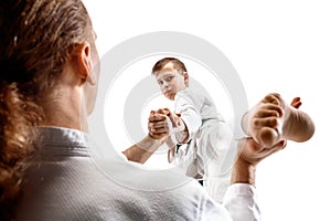 Man and teen boy fighting at aikido training in martial arts school