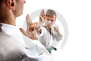 Man and teen boy fighting at aikido training in martial arts school