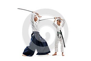 Man and teen boy fighting at aikido training in martial arts school