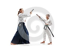 Man and teen boy fighting at aikido training in martial arts school