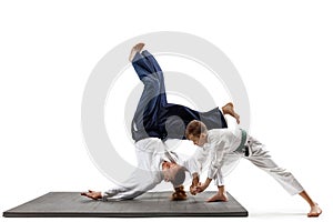 Man and teen boy fighting at aikido training in martial arts school