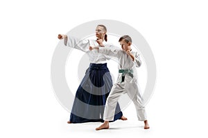 Man and teen boy fighting at aikido training in martial arts school