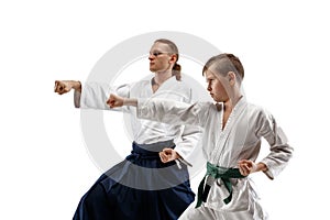 Man and teen boy fighting at aikido training in martial arts school