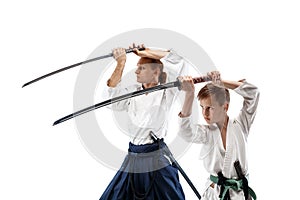 Man and teen boy fighting at aikido training in martial arts school