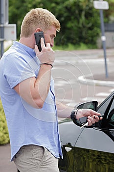 Man on telephone while using remote central locking key