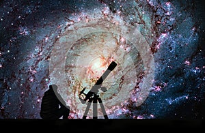 Man with telescope looking at the stars. Messier 83, Southern Pi