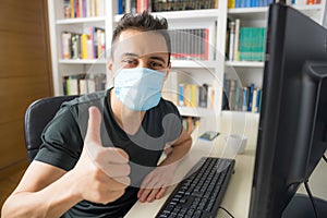 Man teleworking at home with mask