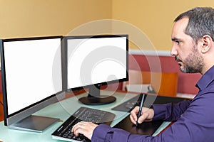 Man teleworking in house with two screens photo