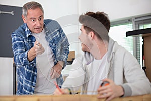 Man telling off student