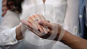 Man tenderly holding fiancee hand with engagement ring, future family, love