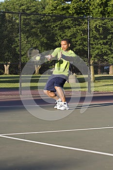 Man on Tennis Court Playing Tennis - Vertical