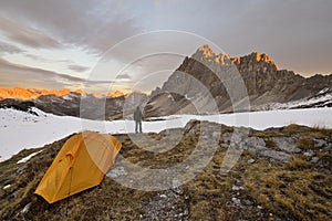 Man with tent observes the Alps photo