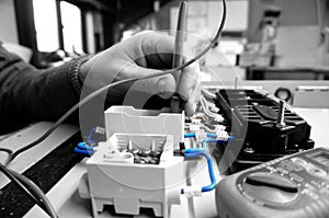 Man testing electric wiring with a Multimeter abstract