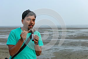 Man testing flavor ice cream. Chuski Or Baraf ka Gola also known as Ice candy, popular roadside refreshment in Indian summering