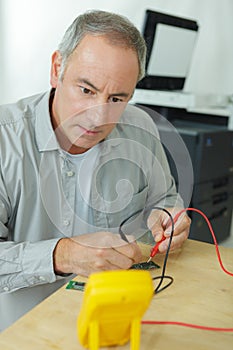 Man testing power using voltmeter