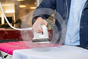 Man Testing Steam Iron Before Buying From Hypermarket photo