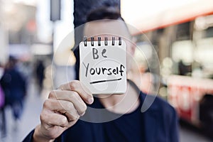 Man and text be yourself in a note