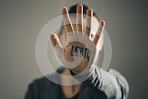 Man with the text LGBTQ in his hand photo