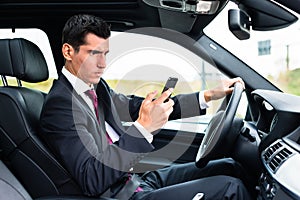 Man texting while driving by car