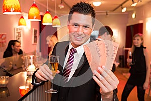 Man in a theatre or cinema presenting tickets