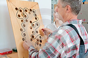 Man with therapist in occupational therapy testing his dexterity