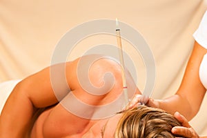 Man in therapy with ear candles